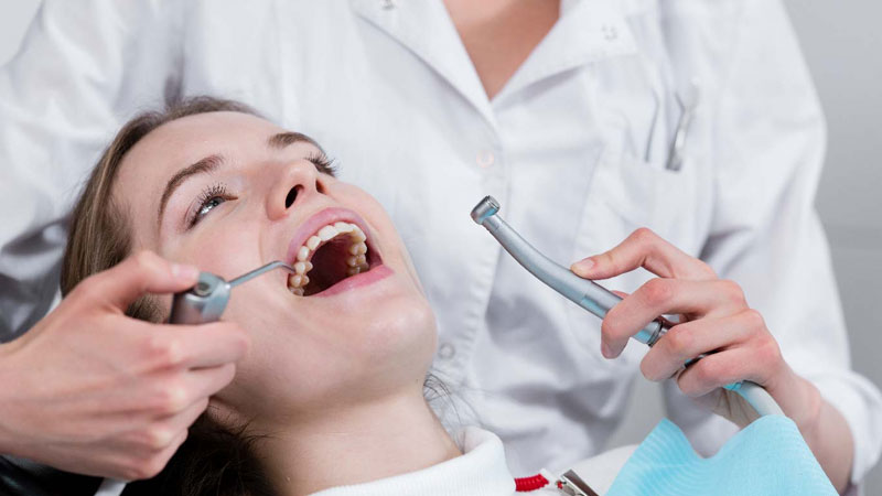 patient undergoing teeth check up for root canal 