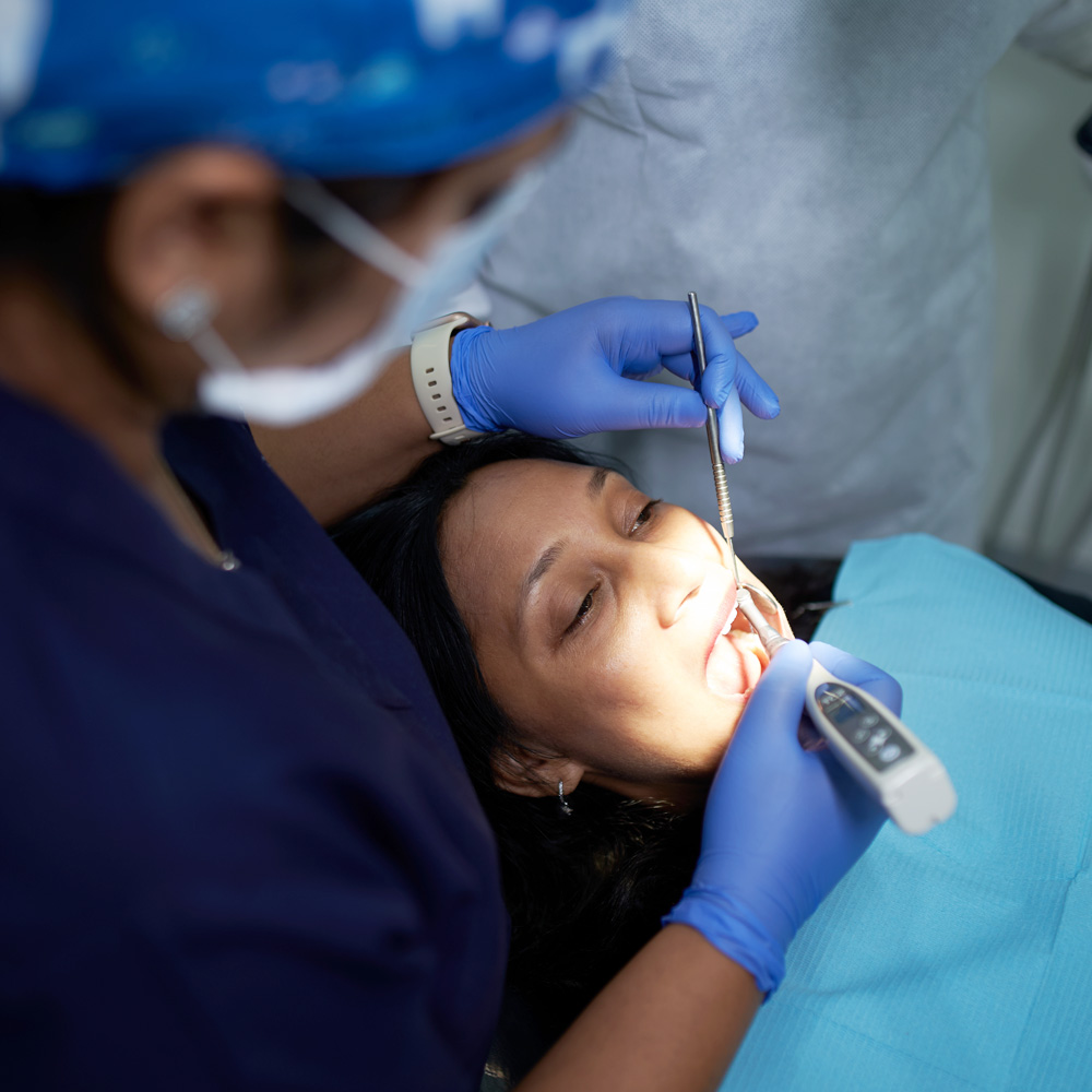 Patient receiving dental filling treatment from dentist at the smile spa dental clinic Juhu